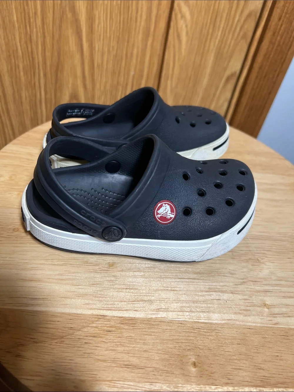 CROCS Kids Black Clogs with White Trim and Red Logo